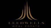 LEED WELLS REAL ESTATE logo image