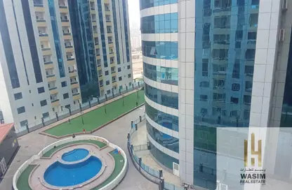 شقة - غرفة نوم - 2 حمامات للايجار في أورينت تاور 1 - أورينت تاور - البستان - عجمان